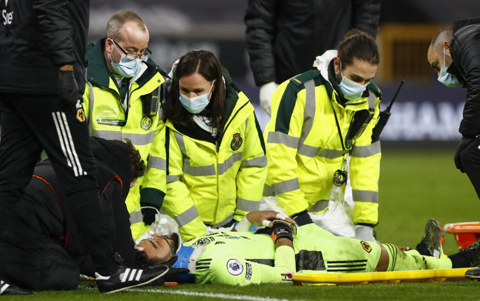 <p>Medical staff attend to Wolverhampton Wanderers' goalkeeper Rui Patricio during the English Premier League soccer match between Wolverhampton Wanderers and Liverpool at Molineux Stadium in Wolverhampton, England, Monday, March. 15, 2021. (AP Photo/Jason Cairnduff,Pool)</p>
