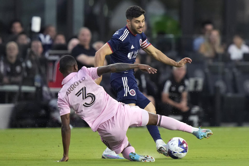 New England Revolution midfielder Carles Gil, right, controls the ball as Inter Miami midfielder Dixon Arroyo (3) defends during the first half of an MLS soccer match Saturday, May 13, 2023, in Fort Lauderdale, Fla. (AP Photo/Lynne Sladky)