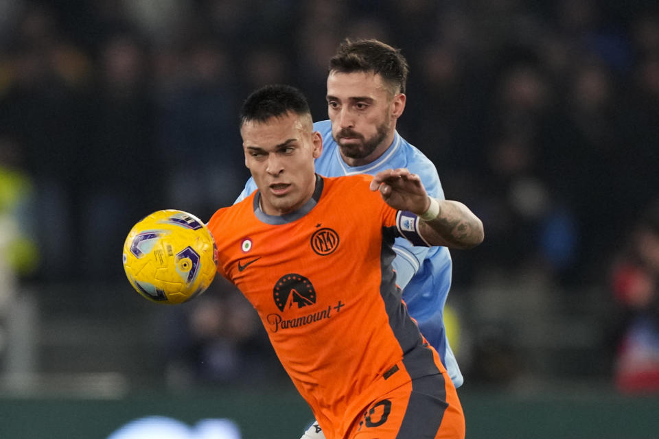 Inter Milan's Lautaro Martinez, left, challenges for the ball with Lazio's Mario Gila during a Serie A soccer match between Lazio and Inter Milan, at Rome's Olympic Stadium, Sunday, Dec. 17, 2023. (AP Photo/Andrew Medichini)