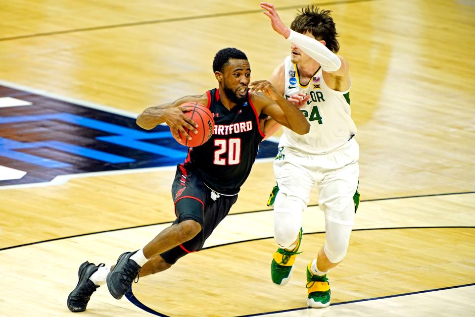 Hartford Hawks guard Austin Williams (20) drives to the basket Baylor Bears guard Matthew Mayer (24) during the second half in the first round of the 2021 NCAA Tournament