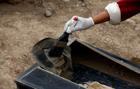 Archaeologist works at a tomb of one of sixteen Chinese migrants, discovered buried at the turn of the 20th century in the pre-colombian pyramid of Bellavista, according to Ministry of Culture, in Lima, Peru, August 24, 2017. REUTERS/Mariana Bazo