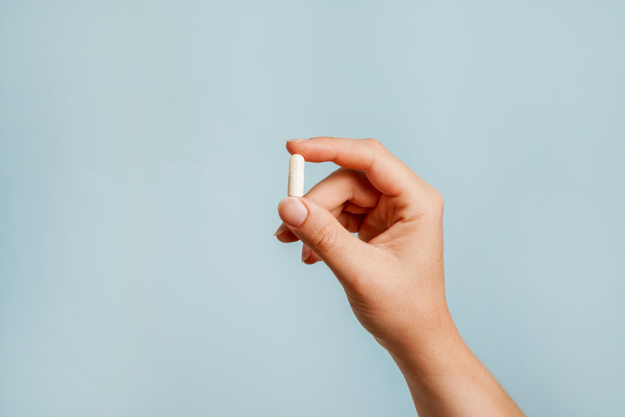 Hand holding a capsule