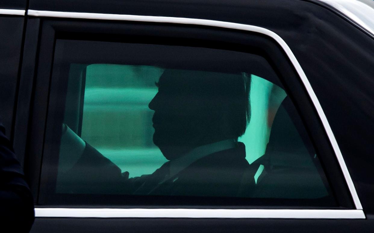 President Donald Trump, being driven in The Beast. Before Secret Service took over chauffeur duty, he was driven by Noel Cintron, who is now suing for unpaid overtime - EPA