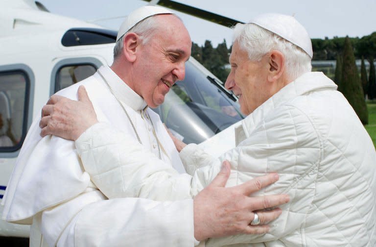 Picture released by the Vatican press office on March 23, 2013 shows "pope emeritus" Benedict XVI (R) greeting Pope Francis upon his arrival at the heliport in Castel Gandolfo. Pope Francis flew in to a papal residence near Rome on Saturday for an unprecedented encounter with Benedict XVI -- the first time a pontiff has met his predecessor