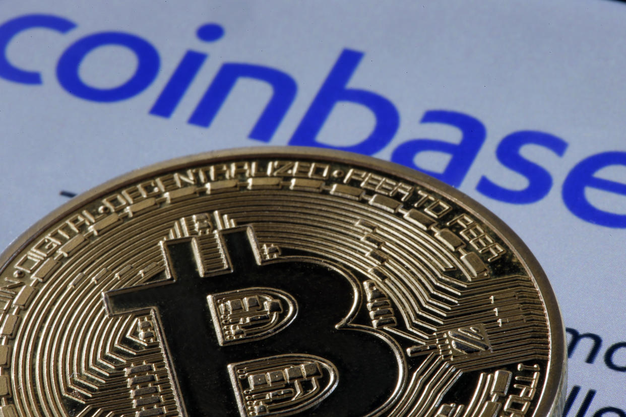 PARIS, FRANCE - APRIL 12: In this photo illustration, a visual representation of the digital Cryptocurrency, Bitcoin, is displayed in front of the home page of the Coinbase cryptocurrency exchange website on April 12, 2021 in Paris, France. Coinbase, America's leading cryptocurrency exchange, arrives on Wall Street on Wednesday April 14 as part of a 'direct introduction'. An IPO, eagerly awaited by crypto enthusiasts, which could value the Californian company at more than 100 billion dollars. Taking advantage of exploding demand for digital currencies, Coinbase said last week that it expects to make a profit of $730 million to $800 million in the first quarter of 2021, more than double the total profit in 2020. Revenues for the first three months of 2021 have likely exceeded last year's, to nearly $1.8 billion. (Photo by Chesnot/Getty Images)