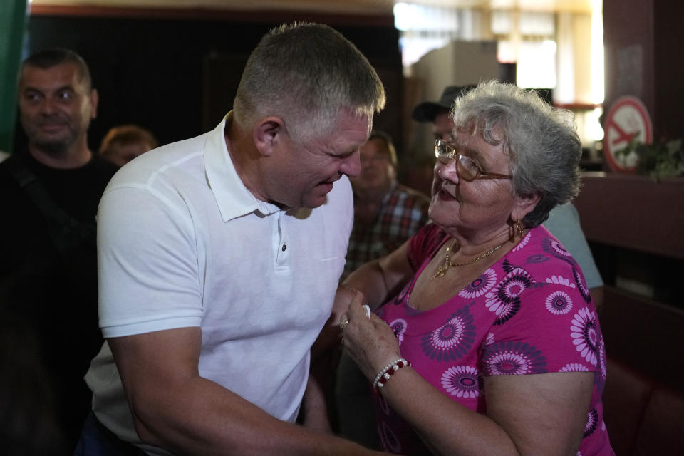 Former Slovak Prime Minister and head of leftist SMER - Social Democracy party Robert Fico, left, greets a supporter during an election rally in Michalovce, Slovakia, Wednesday, Sept. 6, 2023. Fico, who led Slovakia from 2006 to 2010 and again from 2012 to 2018, might reclaim the prime minister's office after the Sept. 30 election. He and his left-wing Direction ("Smer")-Social Democracy party have campaigned on a clear pro-Russian and anti-American message. (AP Photo/Petr David Josek)