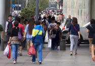 Crowd of people walking on a street in the Xidan district of Beijing. Xidan is one of the main shopping areas in Beijing and is the district favoured by the locals of Beijing. Credit: Getty Images