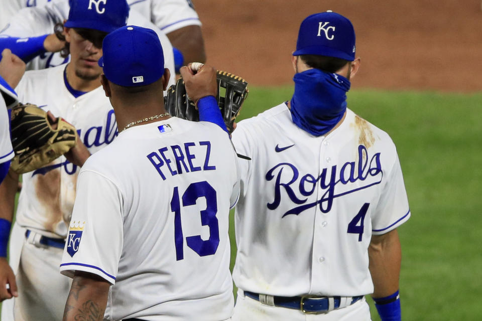 Kansas City Royals Salvador Perez (13) and Alex Gordon (4) celebrate following a baseball game against the Chicago Cubs at Kauffman Stadium in Kansas City, Mo., Thursday, Aug. 6, 2020. (AP Photo/Orlin Wagner)