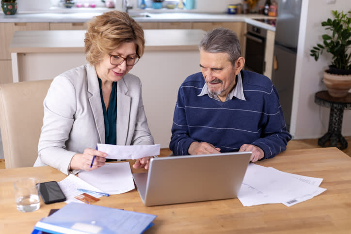 A woman helping her father create a power of attorney in Florida.