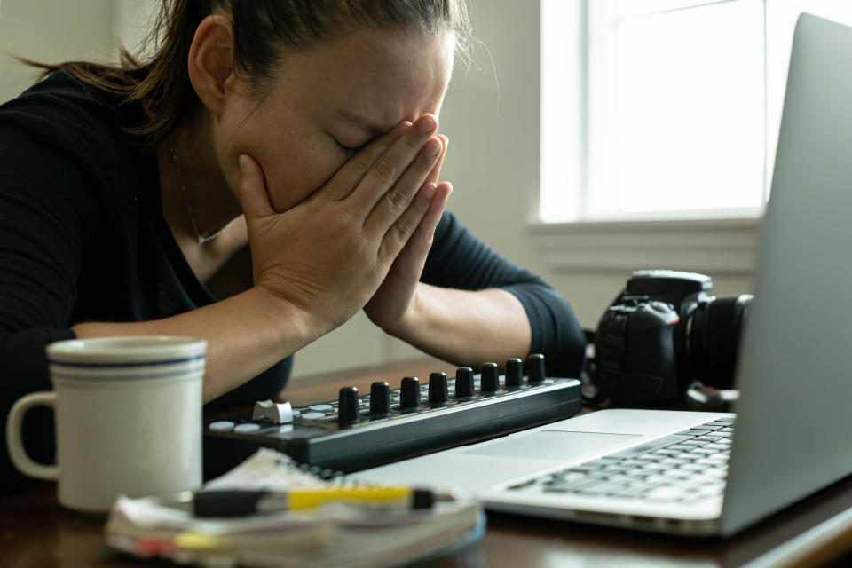 Stressed young woman working at home