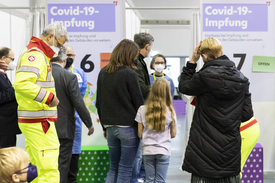 Children wait with their parents to receive the Pfizer vaccine against the COVID-19 disease. The official vaccination for children between the age of 5 and 12 years start today in Vienna, Austria, Monday, Nov. 15, 2021. (AP Photo/Lisa Leutner)