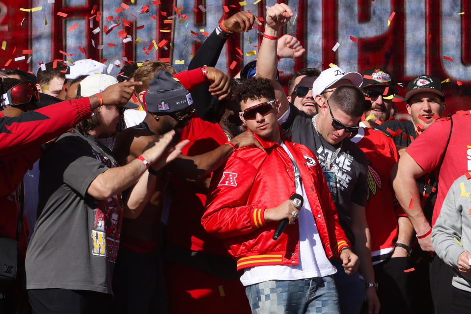 KANSAS CITY, MO - FEBRUARY 14: Kansas City Chiefs player Patrick Mahomes wearing number 15 celebrates on stage with his teammates during the Kansas City Chiefs' 53rd Super Bowl victory parade on February 14, 2024 in Kansas City, Missouri. (Photo by Jamie Squire/Getty Images)