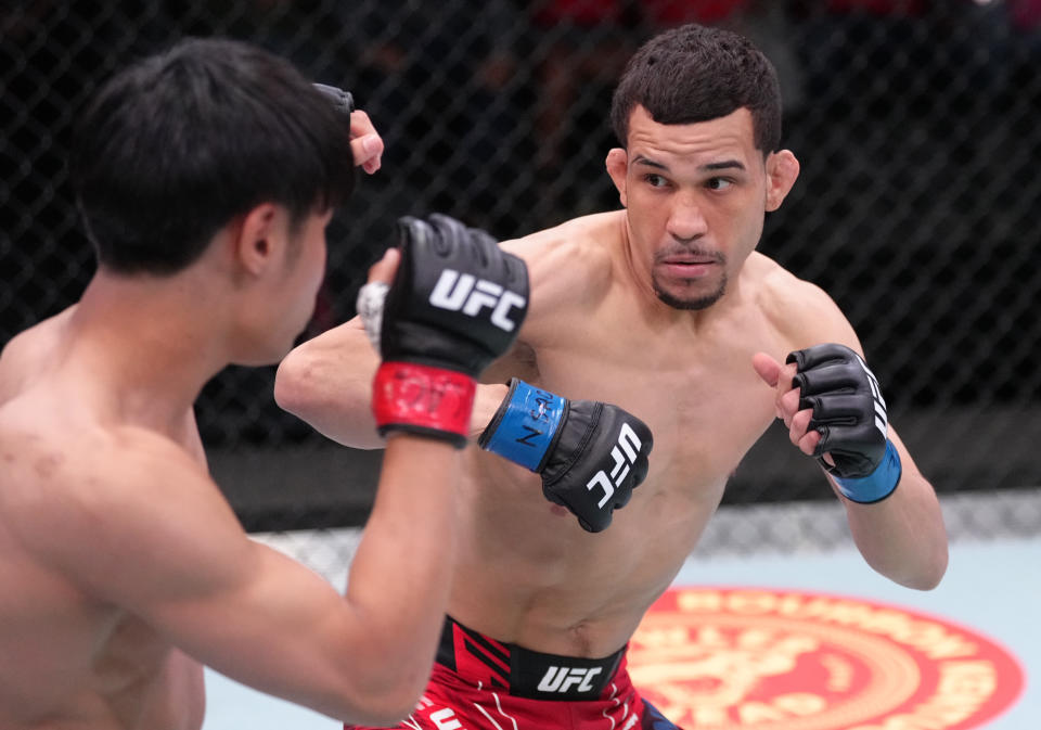 LAS VEGAS, NEVADA – MAY 14: (R-L) Carlos Candelario battles Tatsuro Taira of Japan in a flyweight fight at UFC APEX on May 14, 2022 in Las Vegas, Nevada. (Photo by Jeff Bottari/Zuffa LLC)