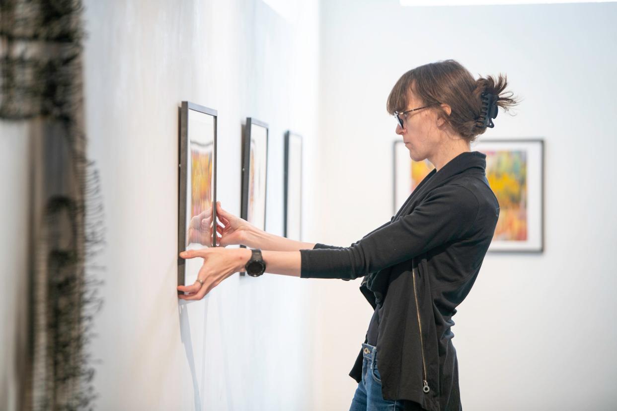 Lise Swanson hangs art at Blo Back Gallery, 131 Spring St., on Thusday, Jan. 5, 2023 ahead of the First Friday Art Walk.