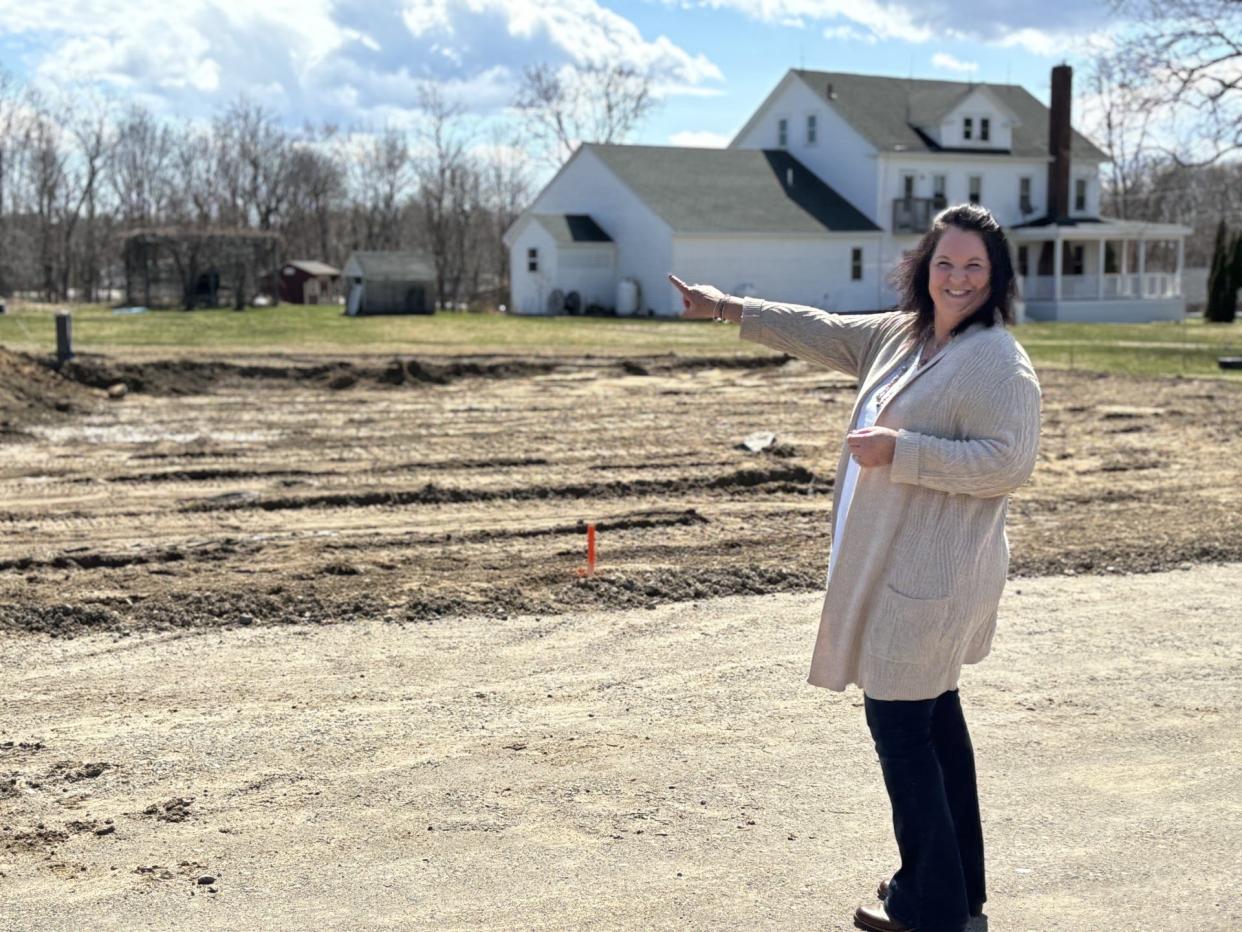 Seen here on April 15, 2024, Gina Sawtelle, who owns and operates Above & Beyond Catering, points out the footprint of her new wedding and events center that is being built at Shaw's Ridge in Sanford, Maine.