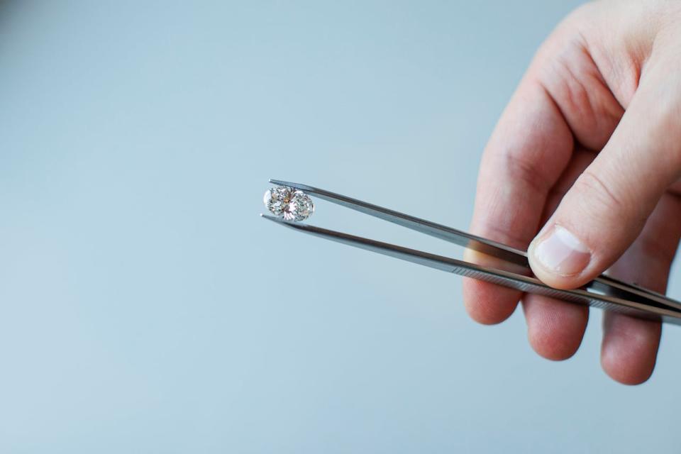 Diamond expert Michael Nehme holds a lab-grown diamond at the Vrai Yorkville showroom in Toronto on Dec. 8. As consumer awareness grows, the popularity of gems that are manufactured, not mined, is surging.  (Evan Mitsui/CBC - image credit)