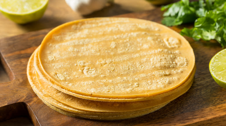 fresh homemade corn tortillas on wood board