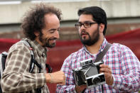 BERLIN, GERMANY - JULY 21: An attendee shows another his Polaroid Land Camera at the second annual Hipster Olympics on July 21, 2012 in Berlin, Germany. With events such as the "Horn-Rimmed Glasses Throw," "Skinny Jeans Tug-O-War," "Vinyl Record Spinning Contest" and "Cloth Tote Sack Race," the Hipster Olympics both mocks and celebrates the Hipster subculture, which some critics claim could never be accurately defined and others that it never existed in the first place. The imprecise nature of determining what makes one a member means that the symptomatic elements of adherants to the group vary in each country, but the archetype of the version in Berlin, one of the more popular locations for those following its lifestyle, along with London and Brooklyn, includes a penchant for canvas tote bags, the carbonated yerba mate drink Club Mate, analogue film cameras, asymmetrical haircuts, 80s neon fashion, and, allegedly, a heavy dose of irony. To some in Berlin, members of the hipster "movement" have replaced a former unwanted identity in gentrifying neighborhoods, the Yuppie, for targets of criticism, as landlords raise rents in the areas to which they relocate, particularly the up-and-coming neighborhood of Neukoelln. (Photo by Adam Berry/Getty Images)