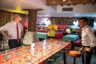 Britain's Prime Minister Boris Johnson (L) and Britain's Chancellor of the Exchequer Rishi Sunak use hand sanitizer on either side of a table football game as they visit Pizza Pilgrims in West India Quay, London Docklands on June 26, 2020 as the restaurant prepares to reopen on July 4 as coronavirus lockdown rules are eased. - The British government on Thursday unveiled plans to get the public out of indoor confinement and on to the streets to boost the economy after three months of coronavirus lockdown. Prime Minister Boris Johnson wants pubs and restaurants to be buzzing in the curtailed summer season, despite continued social distancing rules and restrictions. (Photo by Heathcliff O'Malley / POOL / AFP) (Photo by HEATHCLIFF O'MALLEY/POOL/AFP via Getty Images)