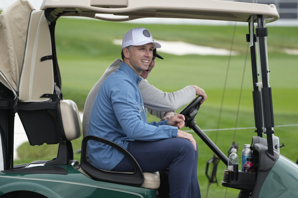 Buster Posey rides in a golf cart on the Pebble Beach Golf Links after finishing a practice round of the AT&T Pebble Beach National Pro-Am golf tournament in Pebble Beach, Calif., Wednesday, Jan. 31, 2024. (AP Photo/Eric Risberg)