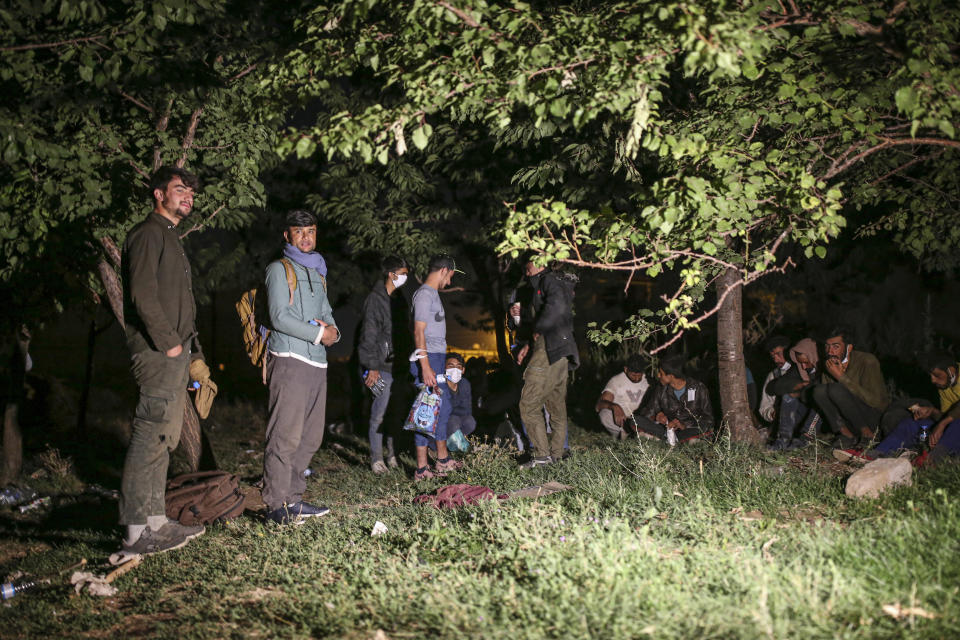 Afghan and Pakistani migrants in the countryside in Tatvan, in Bitlis Province, eastern Turkey, Wednesday, Aug. 18, 2021. Turkey is concerned about increased migration across the Turkish-Iranian border as Afghans flee the Taliban advance in their country. (AP Photo/Emrah Gurel)