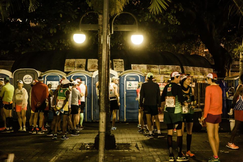 Runners line up to use portable bathrooms.