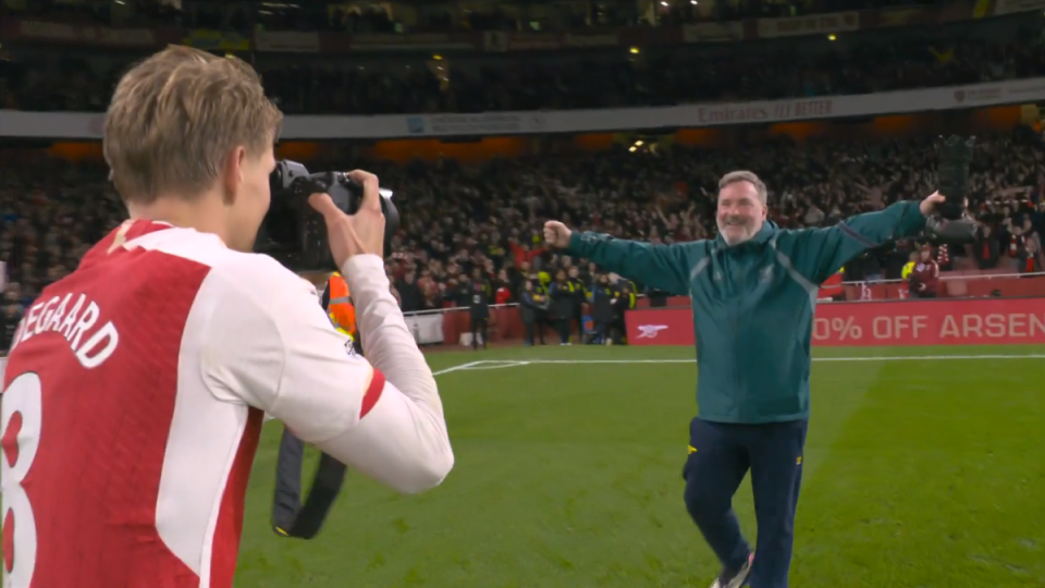 Martin Odegaard celebrates with a club photographer (Sky Sports)