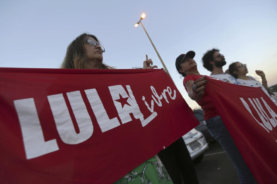 Supporters of Brazil's Former President Luiz Inacio Lula da Silva, display banners with text written in Portuguese that read "Free Lula" during during a protest in front of the Superior Electoral Court, as the trial against the candidacy of the jailed former president continues, in Brasilia, Brazil, Friday, Aug. 31, 2018. Brazil's general elections will be held on October 7. (AP Photo/Eraldo Peres)