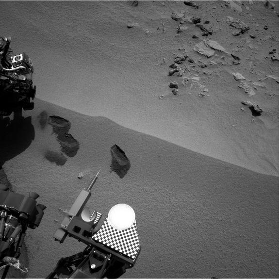 Three bite marks left in the Martian ground by the scoop on the robotic arm of NASA's Mars rover Curiosity are visible in this image taken by the rover's right Navigation Camera during the mission's 69th Martian day, or sol (Oct. 15, 2012). The