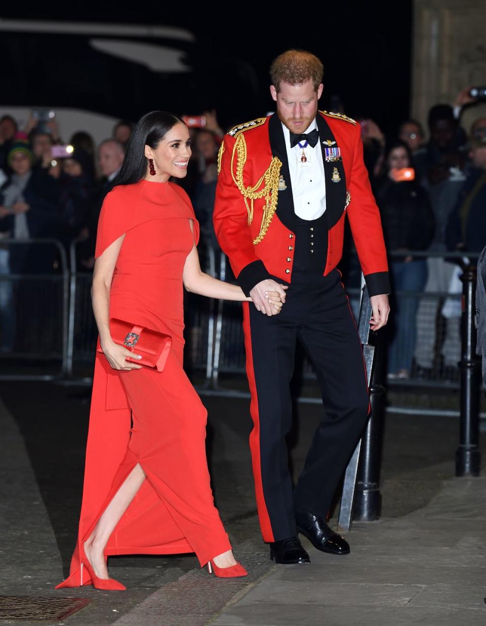 <p>Prince Harry was seen holding his wife's hand and helping her up the steps of the Albert Hall in London on March 7 as they made their way into the <a href="https://www.elle.com/uk/life-and-culture/a31269596/meghan-markle-prince-harry-mountbatten-festival-music/" rel="nofollow noopener" target="_blank" data-ylk="slk:Mountbatten Music Festival;elm:context_link;itc:0;sec:content-canvas" class="link ">Mountbatten Music Festival</a>. </p><p>Meghan wore a beautiful full-length crepe, caped, red dress <a href="https://www.safiyaa.com/products/kalika-long-dress" rel="nofollow noopener" target="_blank" data-ylk="slk:by Safiyaa;elm:context_link;itc:0;sec:content-canvas" class="link ">by Safiyaa</a> for the occasion. </p>