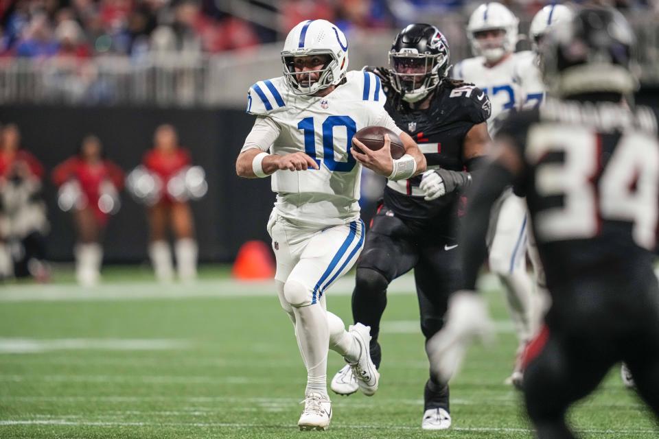 Dec 24, 2023; Atlanta, Georgia, USA; Indianapolis Colts quarterback <a class="link " href="https://sports.yahoo.com/nfl/players/32010" data-i13n="sec:content-canvas;subsec:anchor_text;elm:context_link" data-ylk="slk:Gardner Minshew;sec:content-canvas;subsec:anchor_text;elm:context_link;itc:0">Gardner Minshew</a> (10) runs with the ball against the Atlanta Falcons at Mercedes-Benz Stadium. Mandatory Credit: Dale Zanine-USA TODAY Sports