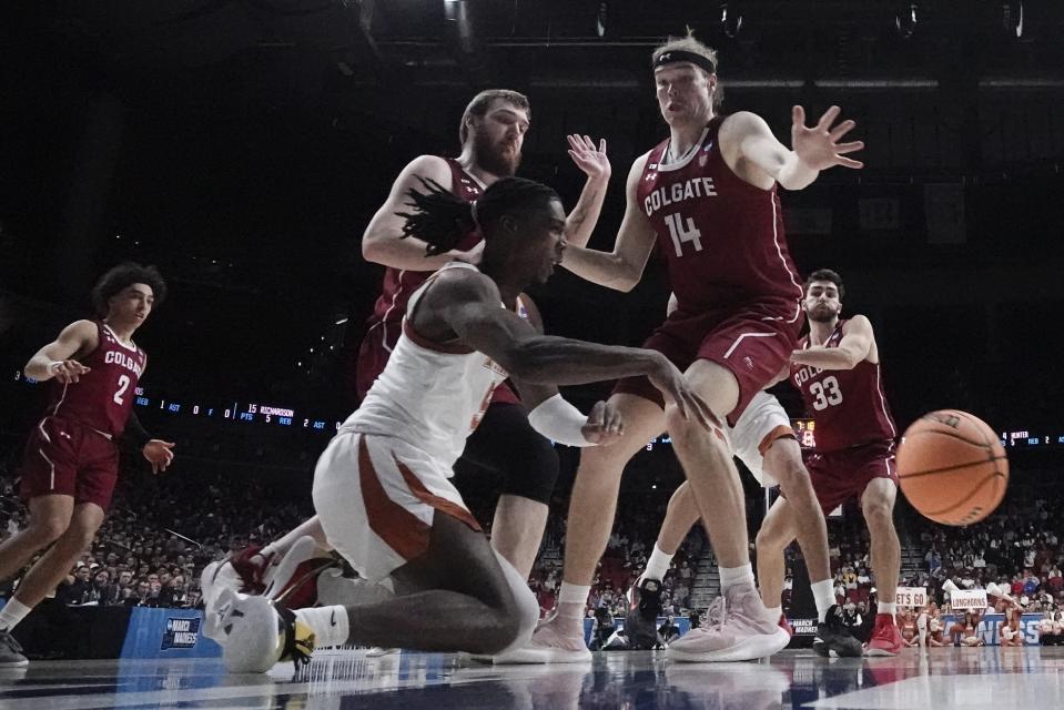 Texas' Marcus Carr passes from the floor during second half of a first-round college basketball game against Colgate in the NCAA Tournament Thursday, March 16, 2023, in Des Moines, Iowa. (AP Photo/Morry Gash)