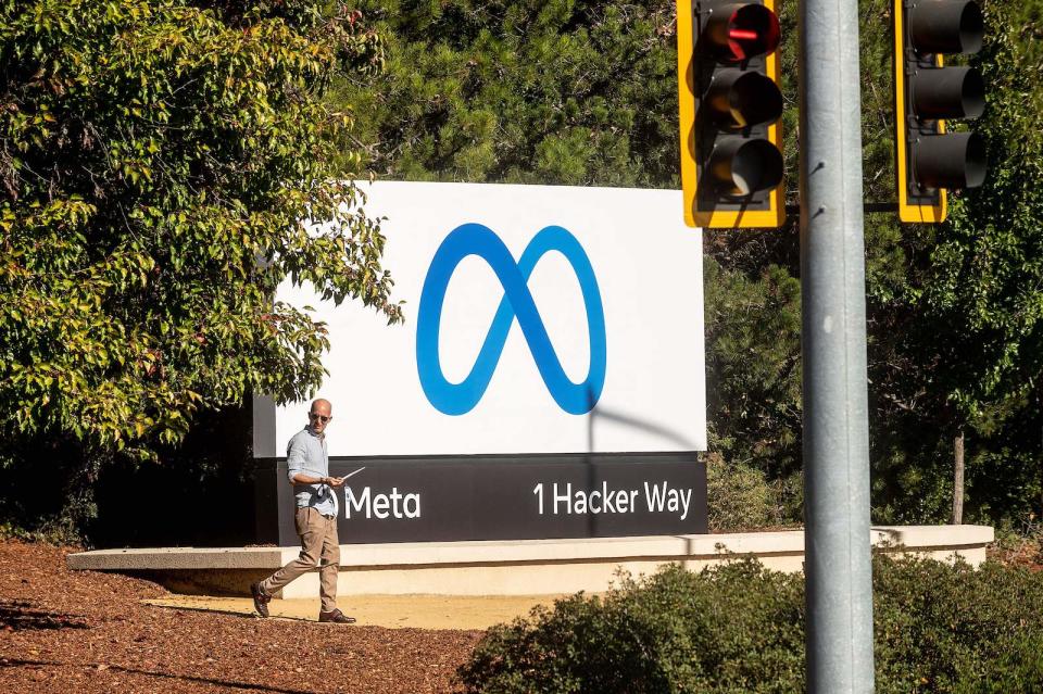 A man passes a newly unveiled logo for 