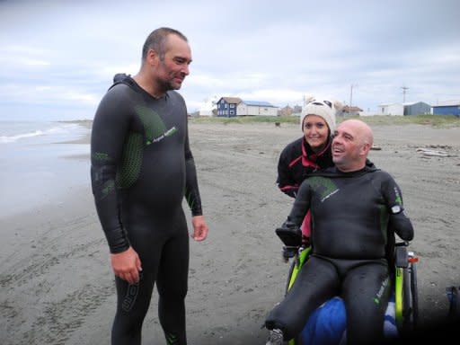 Quadruple amputee Philippe Croizon (right) with swimming companion Arnaud Chassery on a beach in Wales, Alaska. Croizon and Chassery are preparing for the last stage of a challenge that has already seen them swim between Oceania and Asia, Africa and Asia then Europe to Africa since May