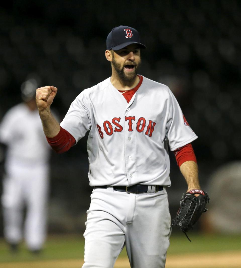 Boston Red Sox relief pitcher Burke Badenhop celebrates the Red Sox's 6-4 win over the Chicago White Sox after the14th inning of a baseball game Thursday, April 17, 2014, in Chicago. (AP Photo/Charles Rex Arbogast)