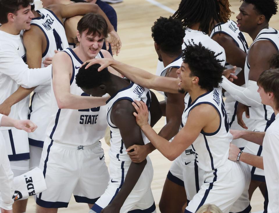 Utah State Aggies celebrate the win over the San Francisco Dons at the Delta Center in Salt Lake City on Saturday, Dec. 16, 2023. USU won 54-53. | Jeffrey D. Allred, Deseret News