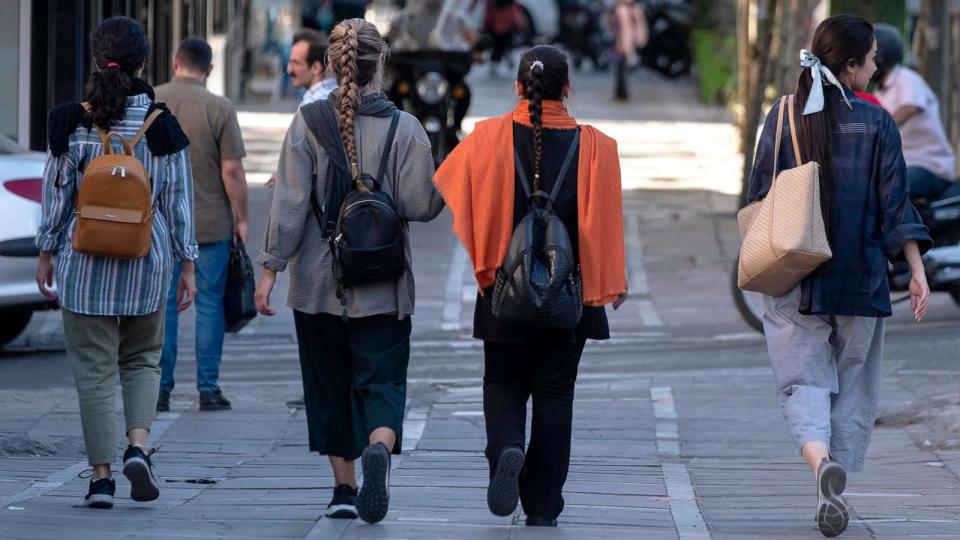 PHOTO: Iranian women without wearing mandatory headscarves, walk along an avenue in downtown Tehran, on Sept. 12, 2023. (Morteza Nikoubazl/NurPhoto via AP)