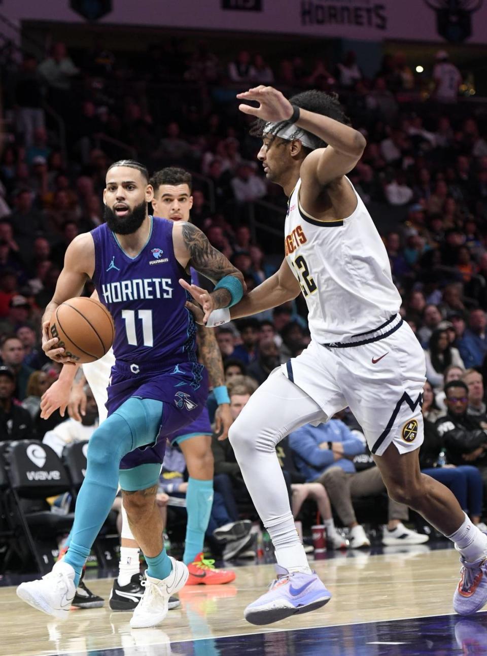 Charlotte Hornets forward Cody Martin (11) drives in during the second half against the Denver Nuggets at the Spectrum Center.