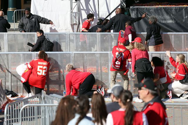 <p>Jamie Squire/Getty</p> People take cover during a shooting at Union Station during the Kansas City Chiefs Super Bowl LVIII victory parade on February 14, 2024 in Kansas City, Missouri. Several people were shot and two people were detained after a rally celebrating the Chiefs Super Bowl victory.