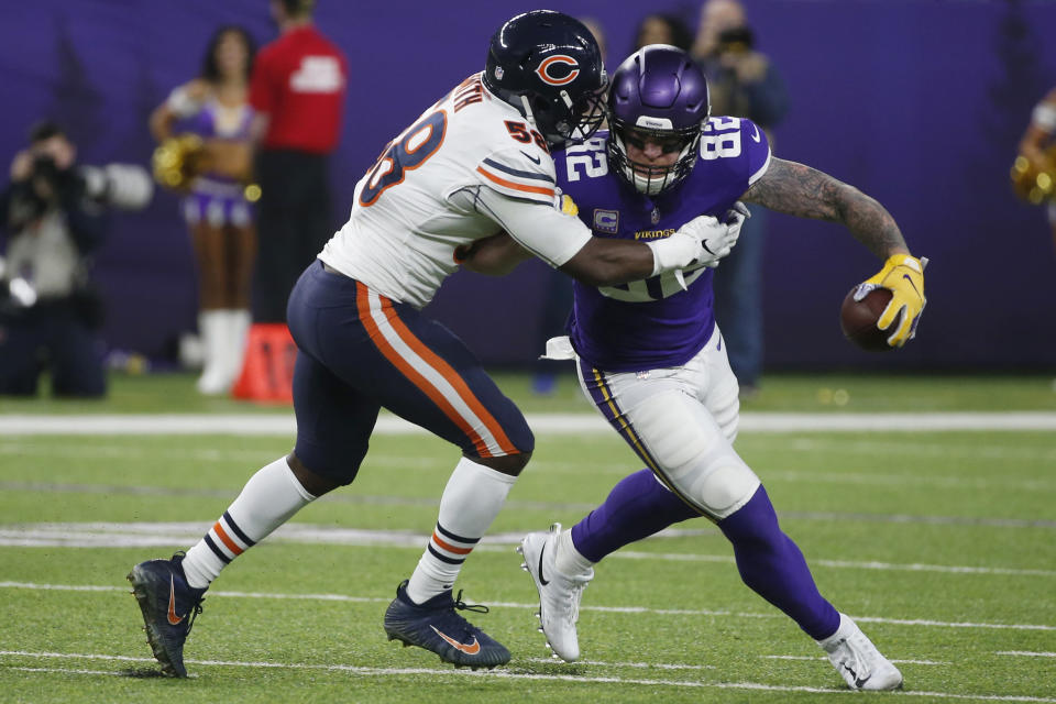 Minnesota Vikings tight end Kyle Rudolph (82) is tackled by Chicago Bears inside linebacker Roquan Smith, left, after catching a pass during the first half of an NFL football game, Sunday, Dec. 30, 2018, in Minneapolis. (AP Photo/Bruce Kluckhohn)