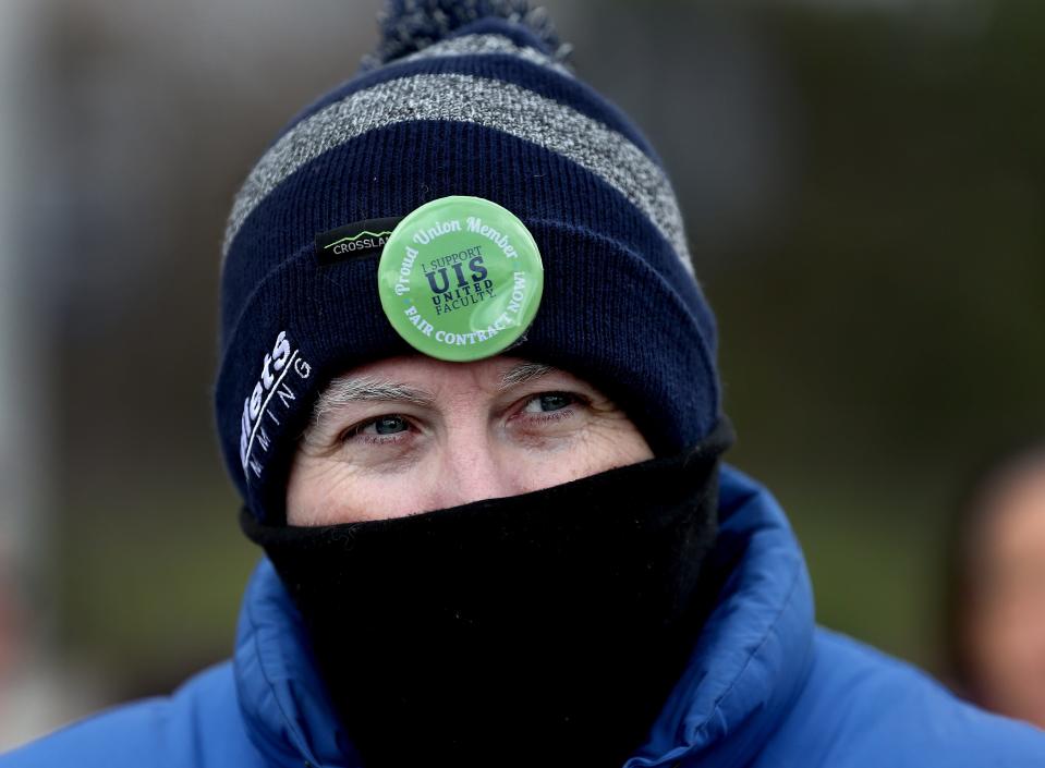 Department of Criminology and Criminal Justice Professor at the University of Illinois Springfield Ryan Williams wears a union button on his cap during a rally held by the UIS teacher's union for a new contract Thursday March 31, 2022. [Thomas J. Turney/ The State Journal-Register]