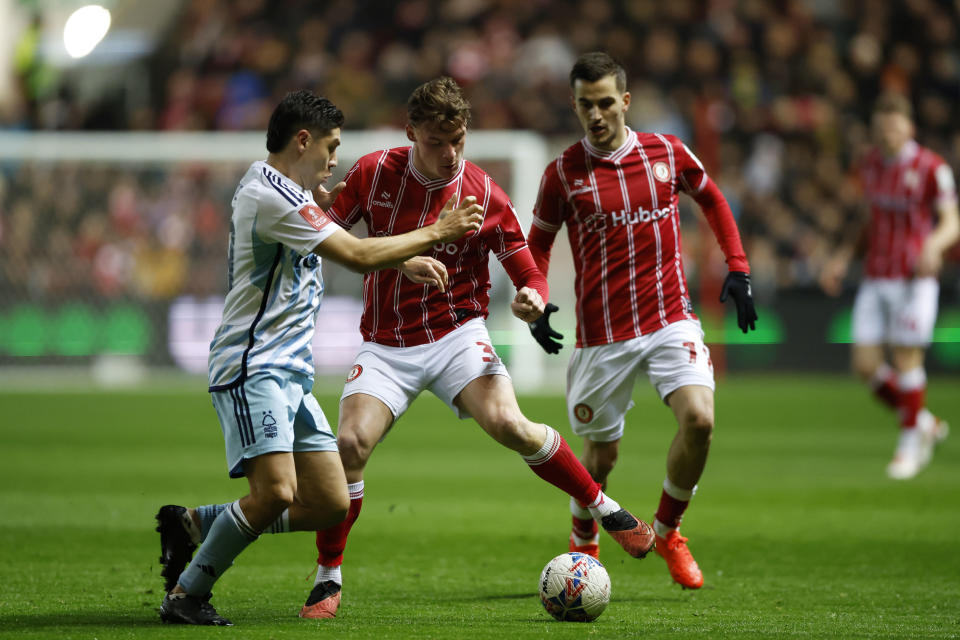 Nottingham Forest's Gonzalo Montiel, left, and Bristol City's Cameron Pring battle for the ball during their English FA Cup fourth round soccer match at Ashton Gate, Bristol, England, Friday, Jan. 26, 2024. (Nigel French/PA via AP)