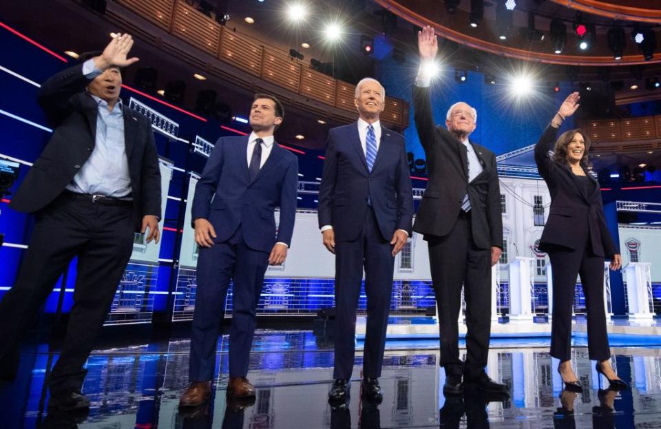 Entrepreneur Andrew Yang, Mayor of South Bend, Ind., Pete Buttigieg, Former Vice President Joe Biden, Vermont Sen. Bernie Sanders and California Sen. Kamala Harris arrive on stage for the second night of the first Democratic primary debate on June 27, 2019. | JIM WATSON—AFP/Getty Images