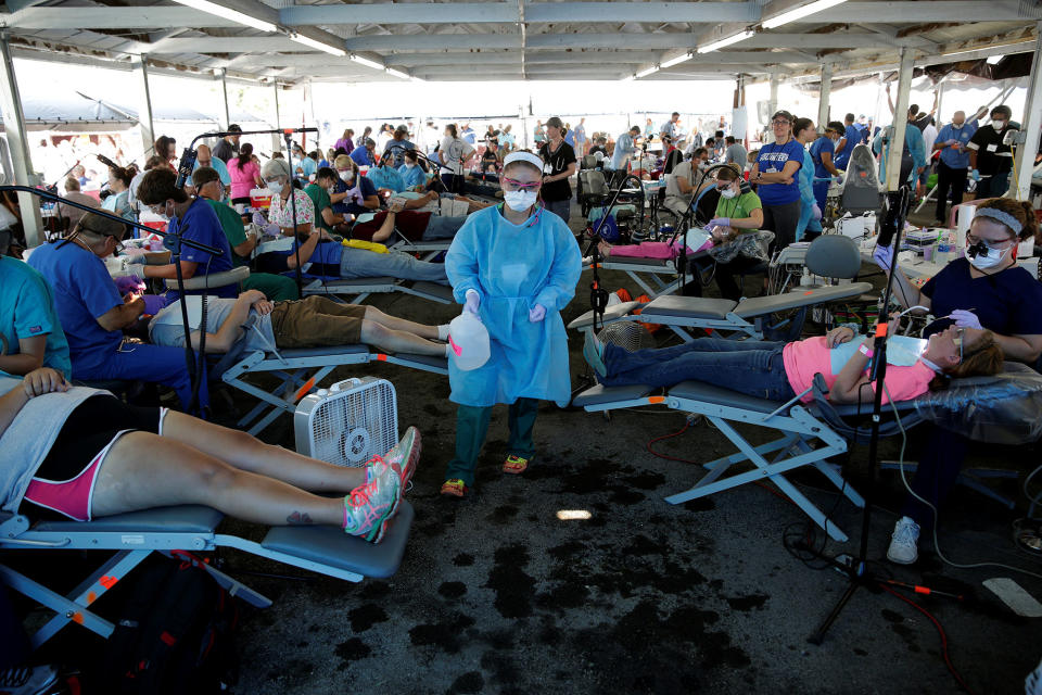 <p>A volunteer walks past people receiving dental care at the Remote Area Medical Clinic in Wise, Va., July 21, 2017. (Photo: Joshua Roberts/Reuters) </p>