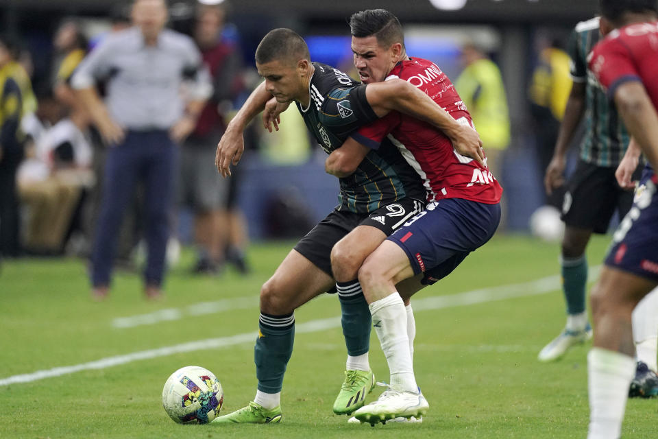 Los Angeles Galaxy forward Dejan Joveljic, left, and Chivas midfielder Eduardo Torres battle for the ball during the first half of a Leagues Cup match Wednesday, Aug. 3, 2022, in Inglewood, Calif. (AP Photo/Mark J. Terrill)