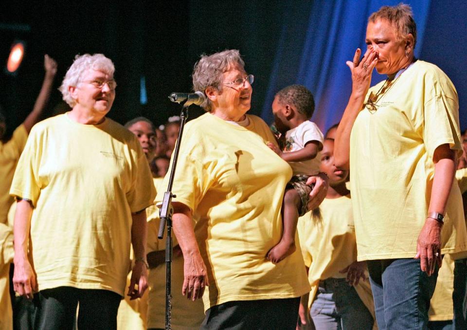 Sister Corita Bussanmas, left, and Sister Berta Sailer, center, watch Connie Crumble wipe tears from her face after the performance of Miracle on 31st Street in 2005. Miracle on 31st Street was a show presenting the history of Operation Breakthrough/St. Vincent’s Family Services Center.