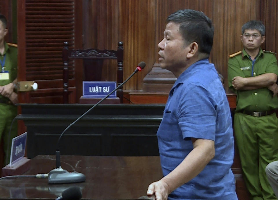 Australian man Chau Van Kham stands at a trial in Ho Chi Minh city, Vietnam Monday, Nov. 11, 2019. Kham was sentenced to 12 years in jail for conducting activities of "terrorism to oppose the people's administration." (Nhan Huu Sang/VNA via AP)