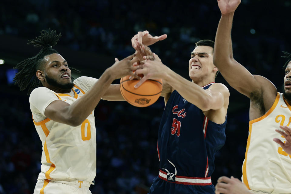 Tennessee forward Jonas Aidoo (0) and Florida Atlantic center Vladislav Goldin (50) reach for the rebound during the first half of a Sweet 16 college basketball game in the East Regional of the NCAA tournament at Madison Square Garden, Thursday, March 23, 2023, in New York. (AP Photo/Adam Hunger)