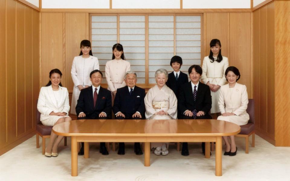 Japanese Emperor Akihito (seated 3rd Left) and Empress Michiko (seated 4th Left), smile with their family members during a photo session for the New Year at the Imperial Palace in Tokyo, Japan last year  - Credit: Imperial Household Agency of Japan