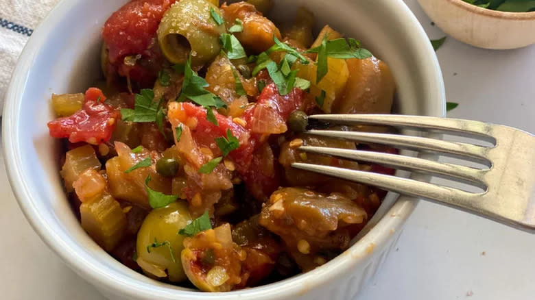 Olives, tomatoes, celery, and eggplant in ramekin